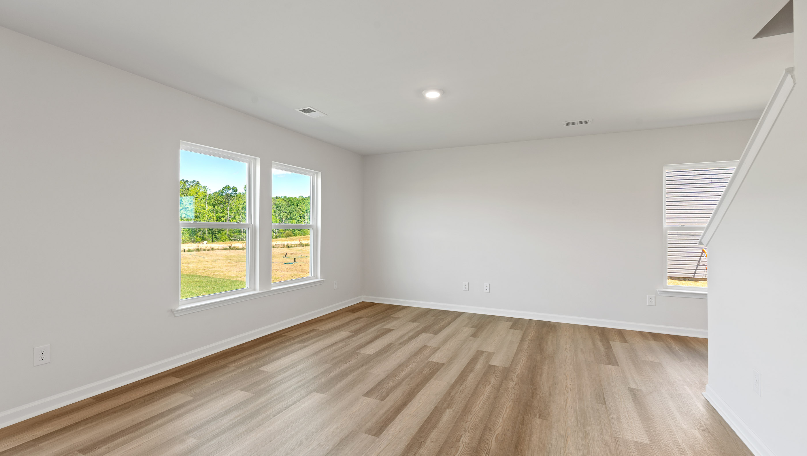 Family room with windows and view of kitchen.