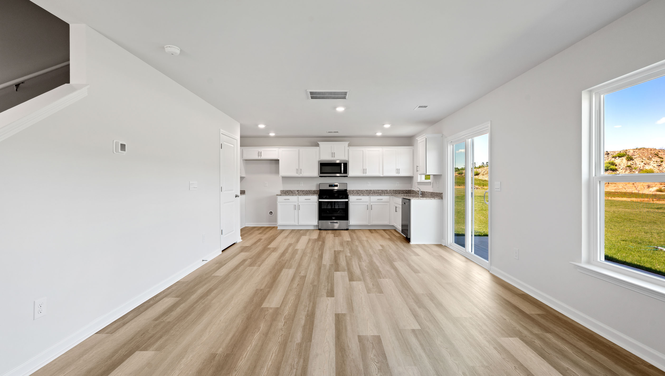 Family room with windows and view of kitchen.