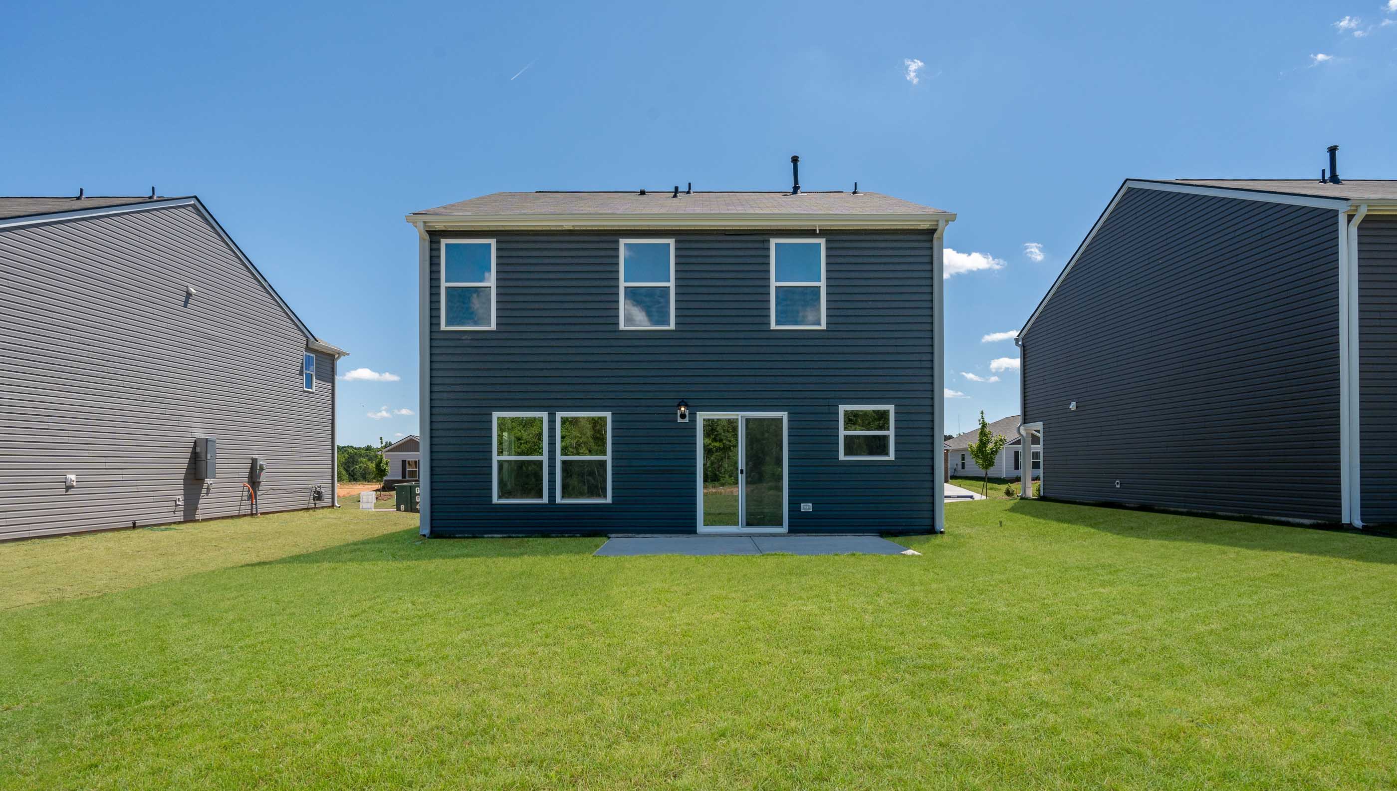 Rear view of home with large backyard.