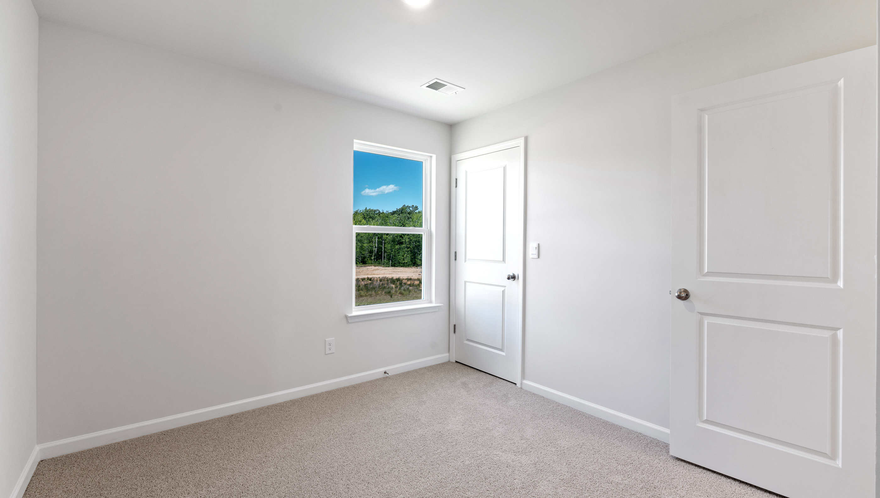 Bedroom with window and carpet.