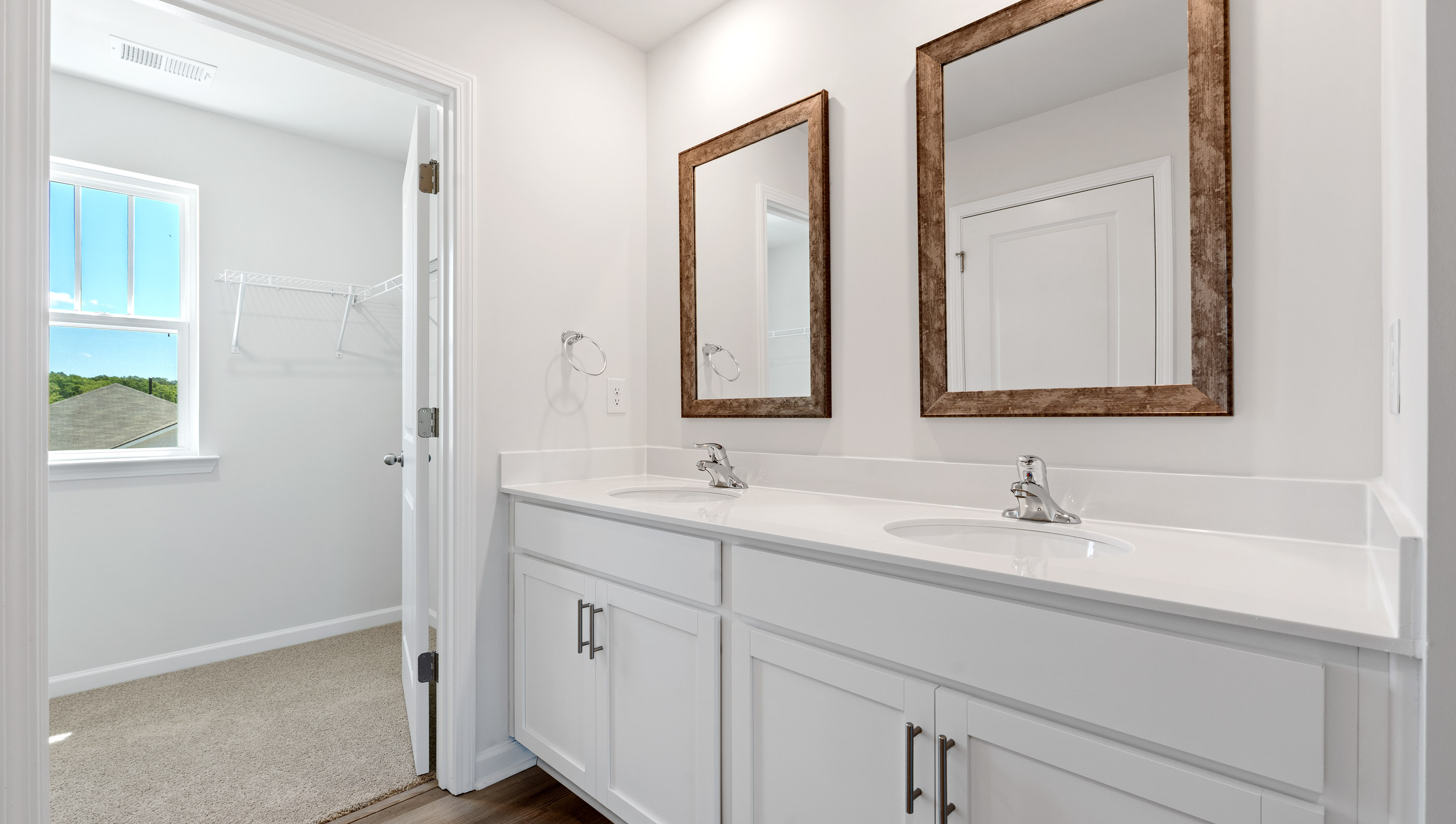 View of primary bathroom with dual sink vanity.