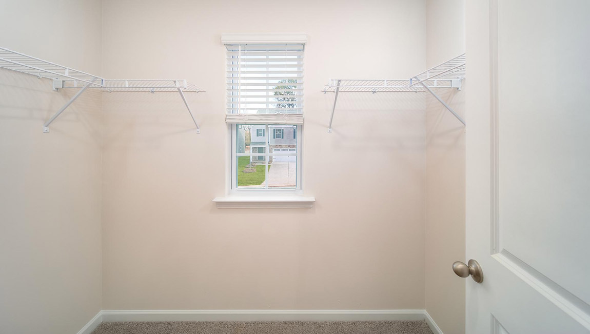 Closet with hanging storage racks.