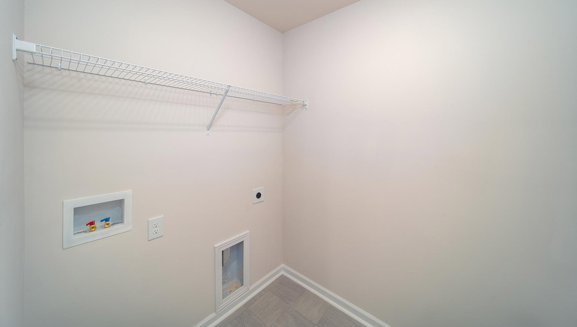 Laundry room with hanging storage racks.