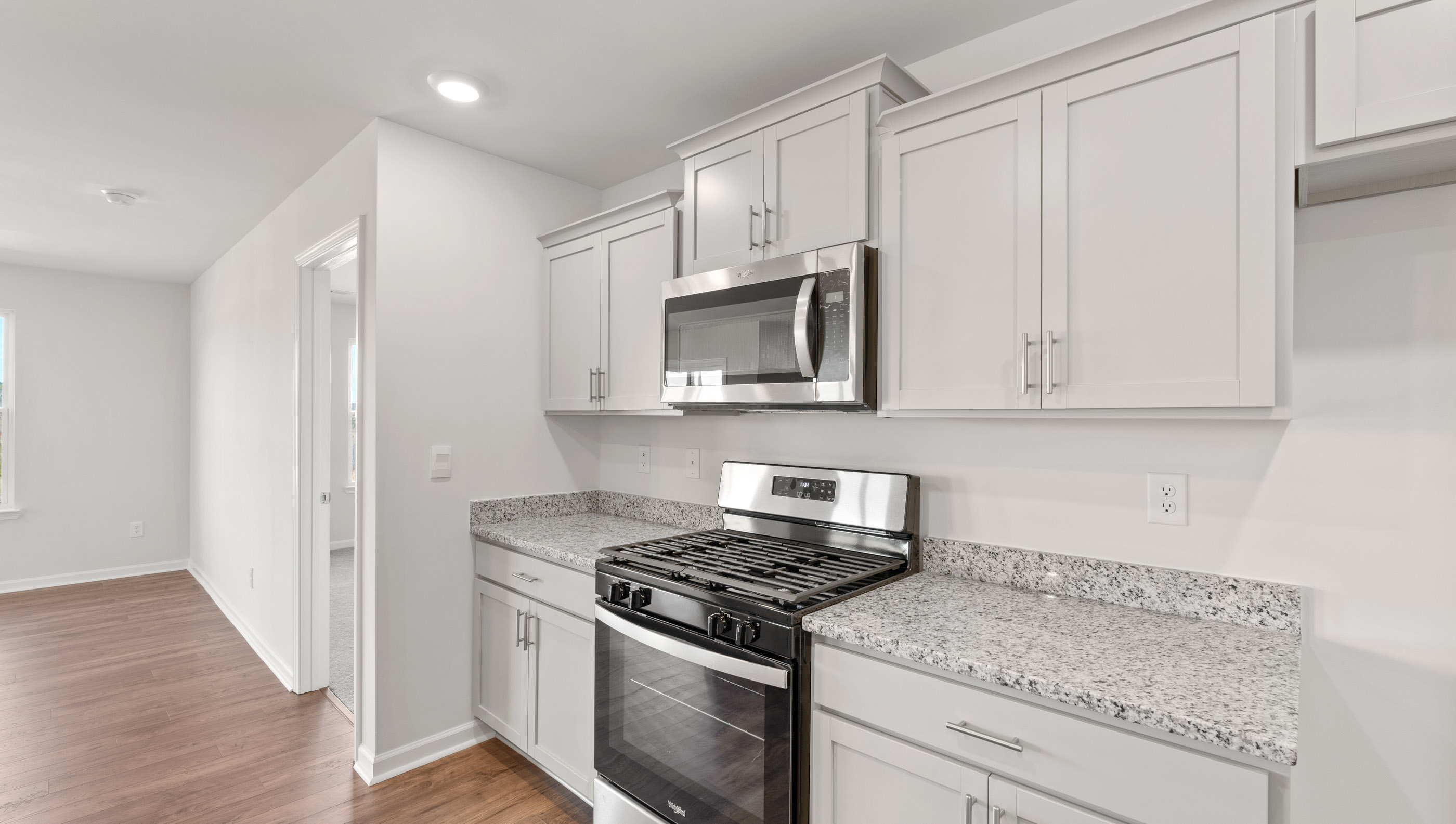 Kitchen with island and granite countertops.