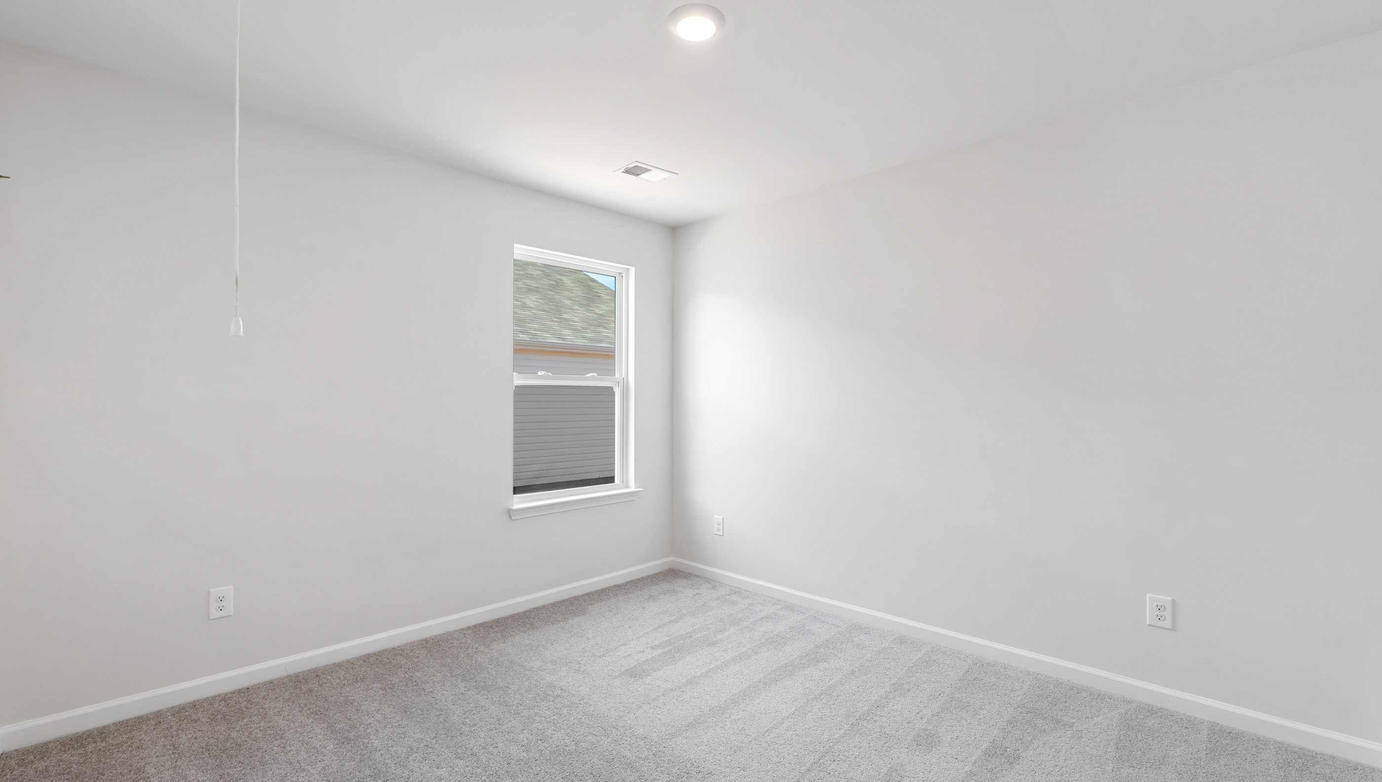 Bedroom with carpet and windo.