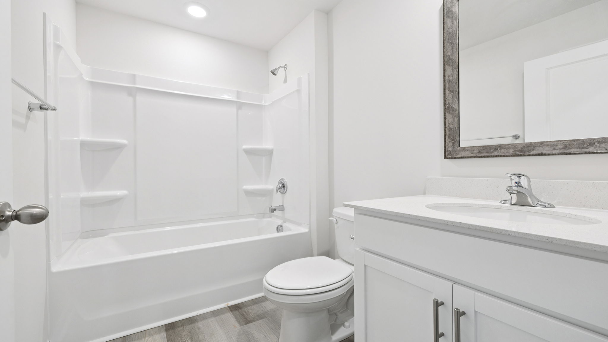 Hall bathroom with vanity and combination shower / tub.