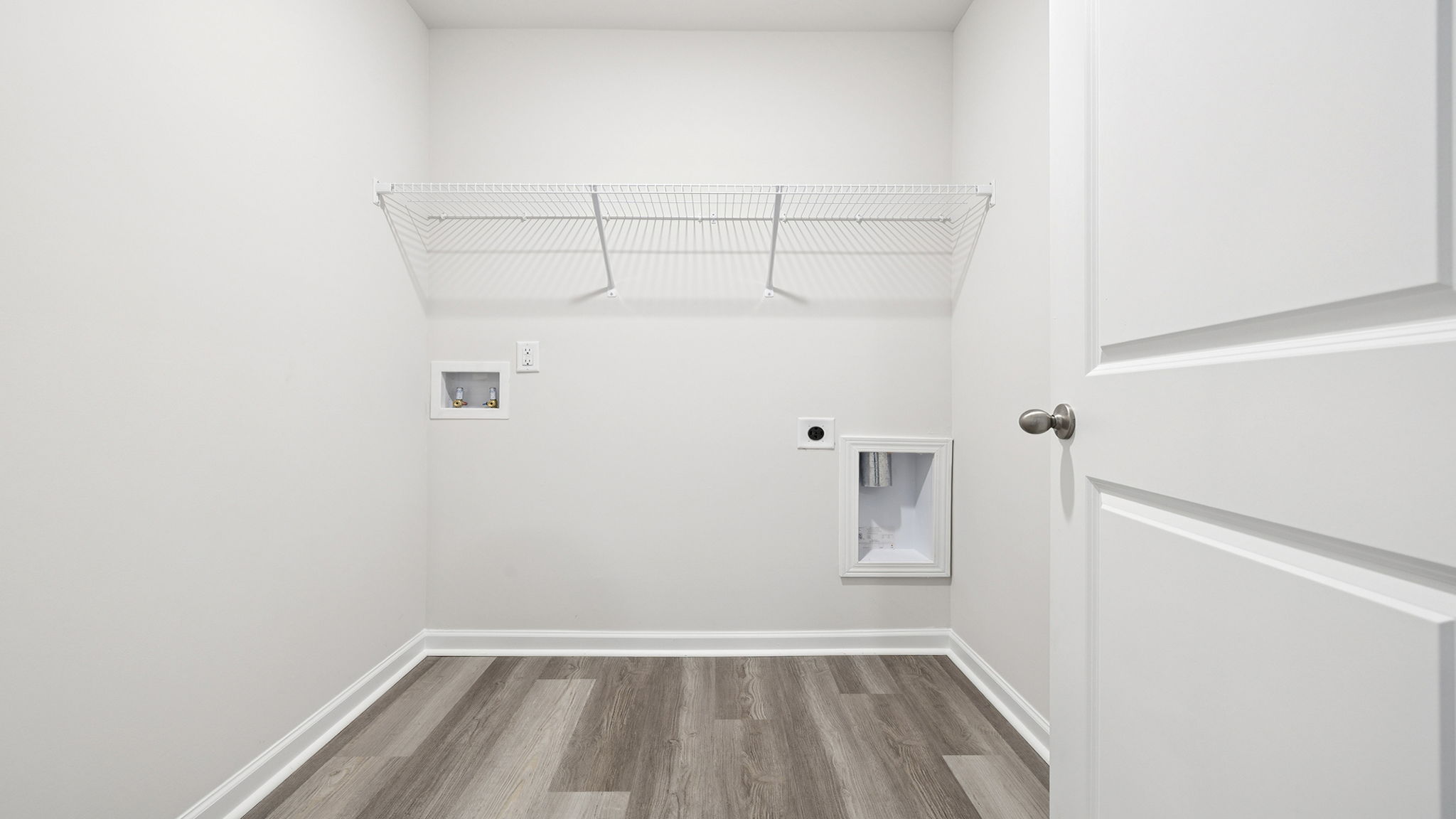 Walk-in laundry room with shelving.