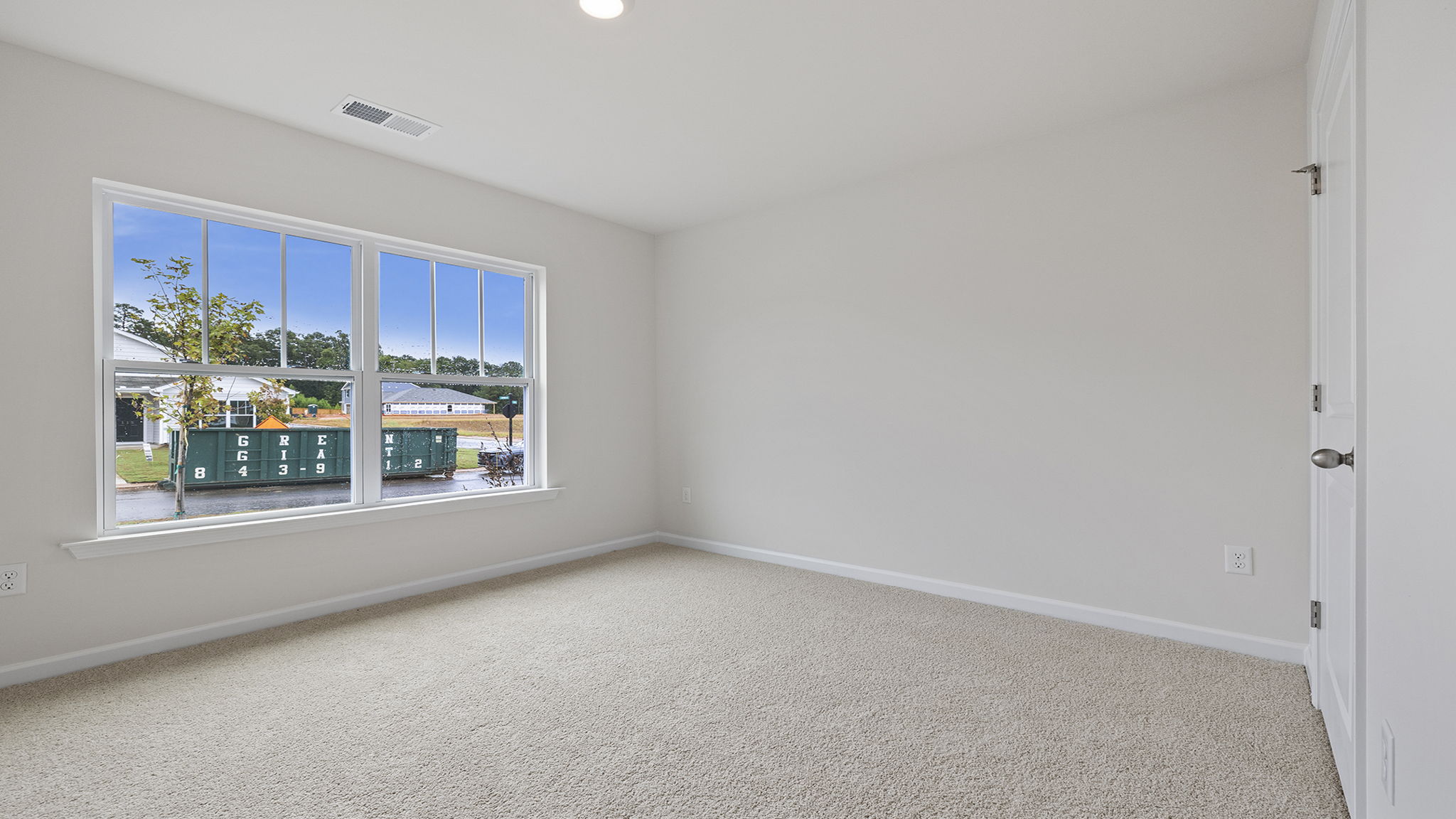 Bedroom with carpet and windows.