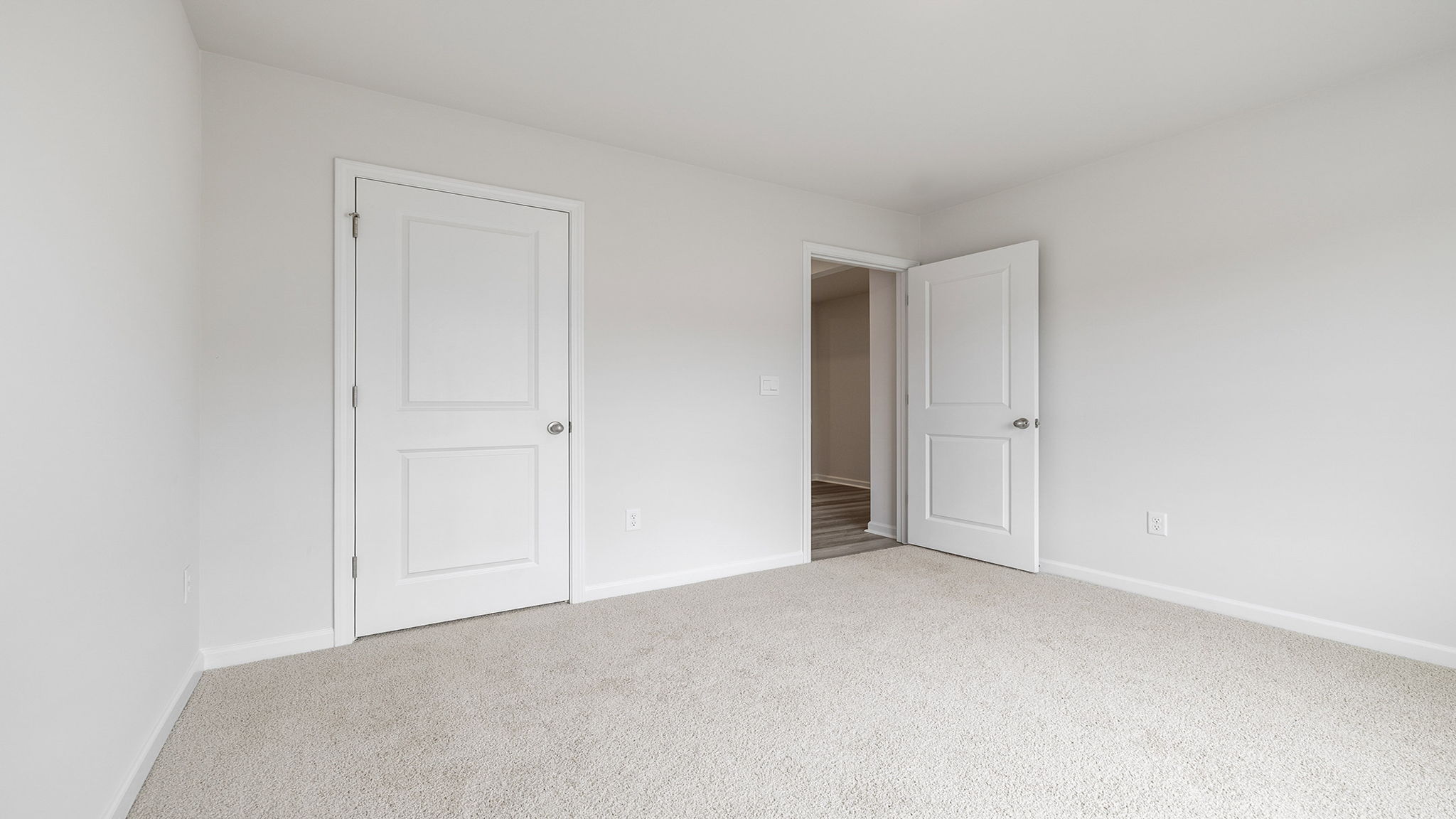 Bedroom with carpet and windows.