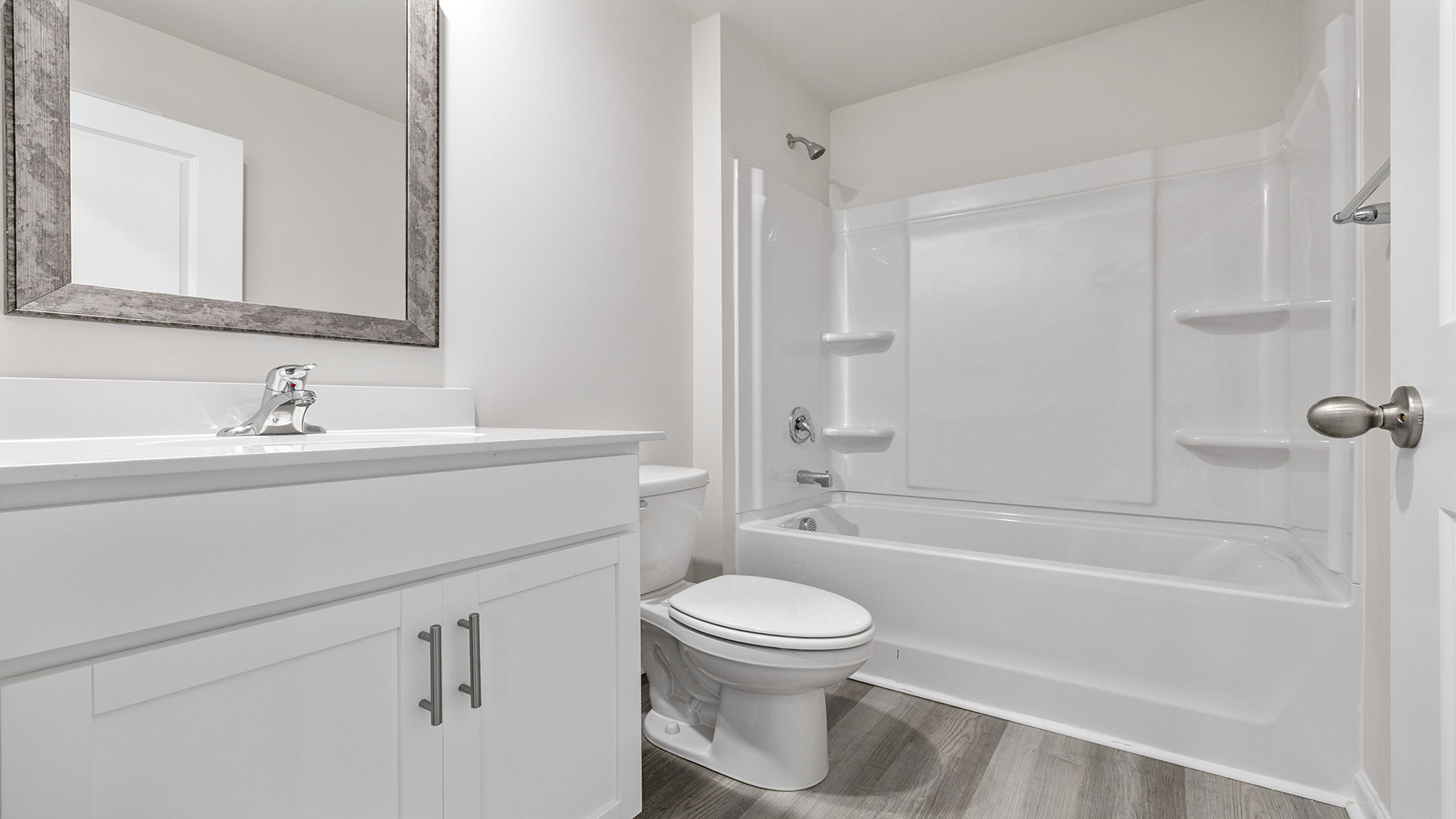 Hall bathroom with vanity and combination shower / tub.