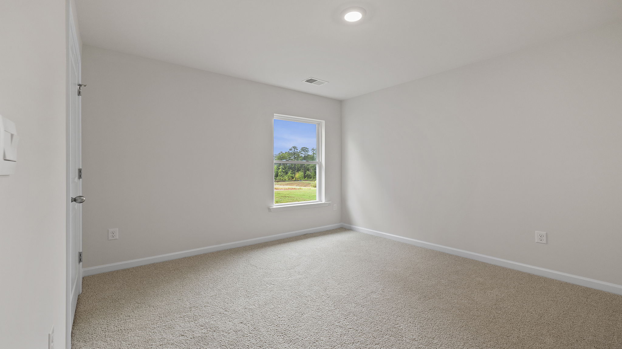 Bedroom with carpet and windows.