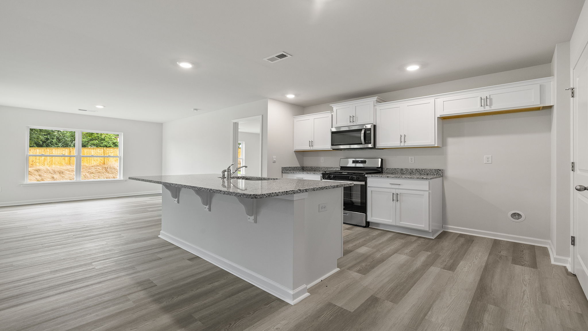 Kitchen open to the combination family and dining areas.