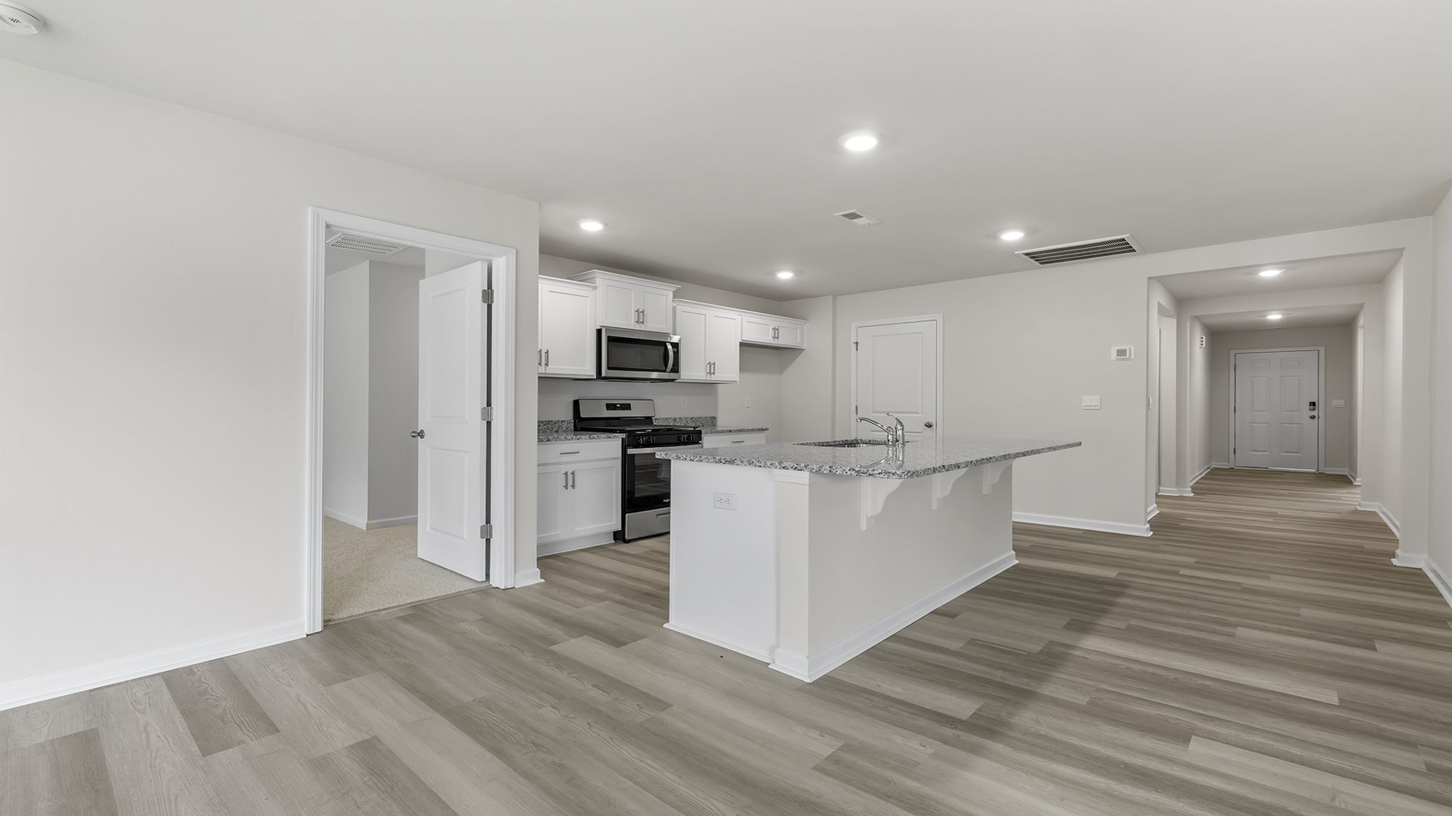 View of the kitchen and hallway toward the entrance.