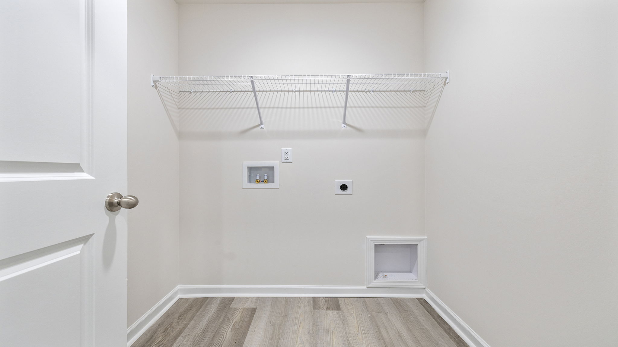 Walk-in laundry room with shelving.