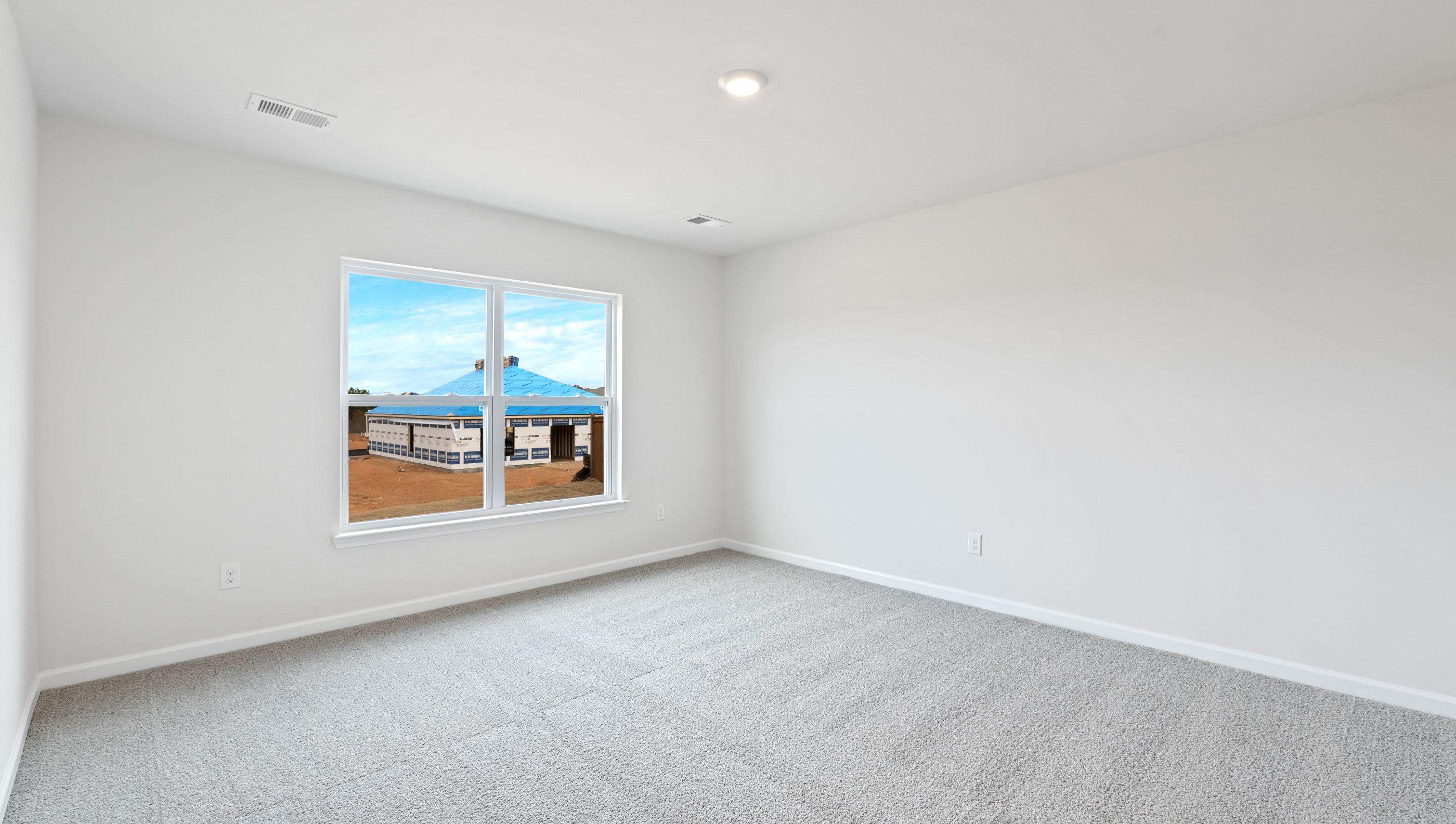 Bedroom with carpet and window.