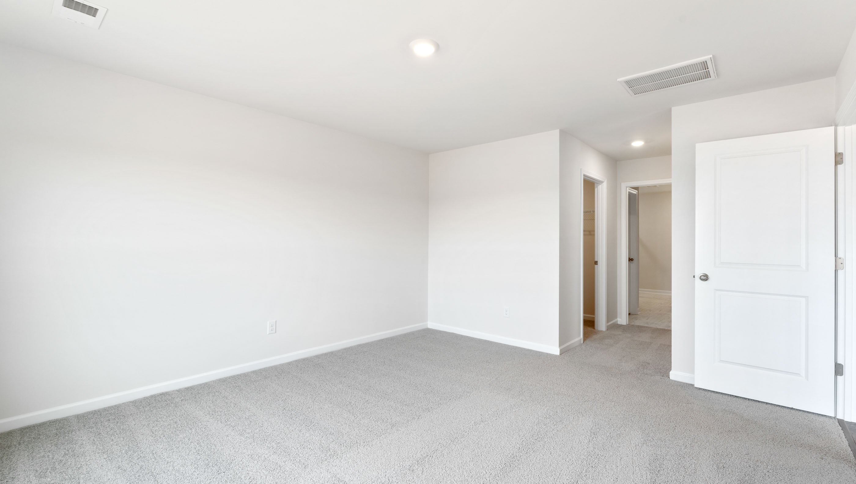 Bedroom with carpet and window.
