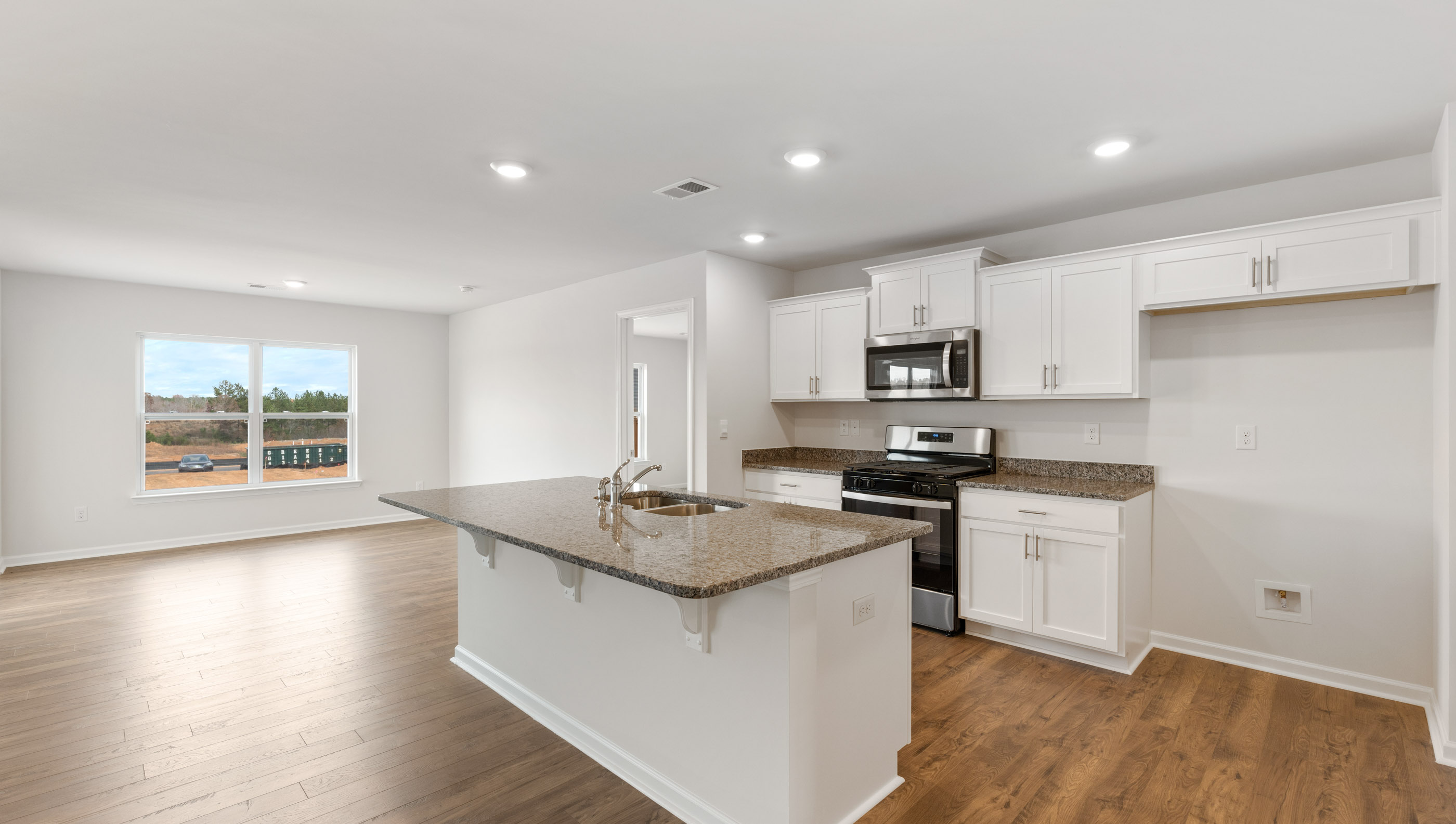 Kitchen and island with granite counter tops.