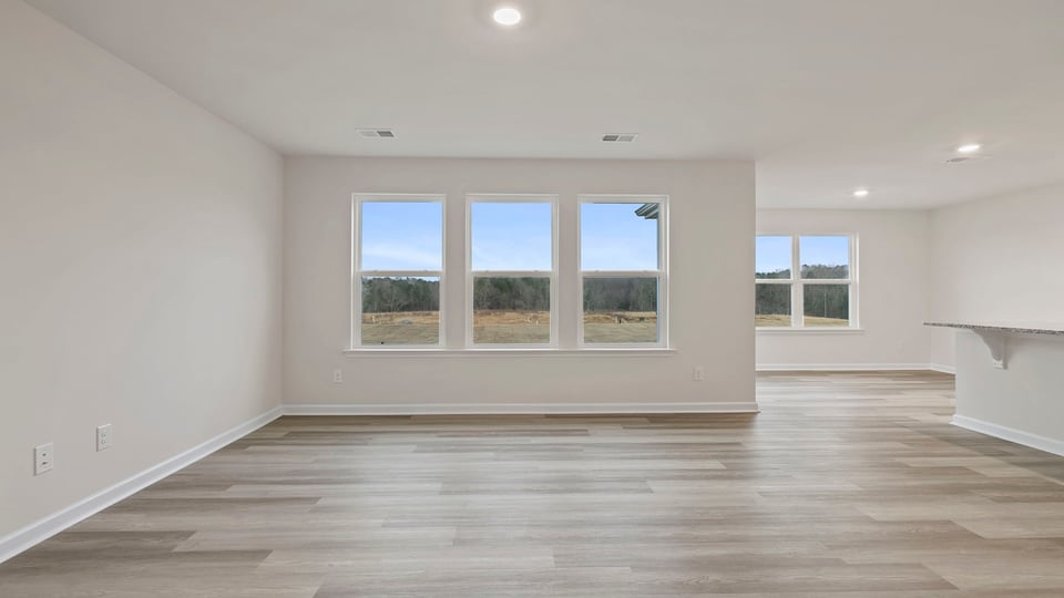 View of family room with three large windows.