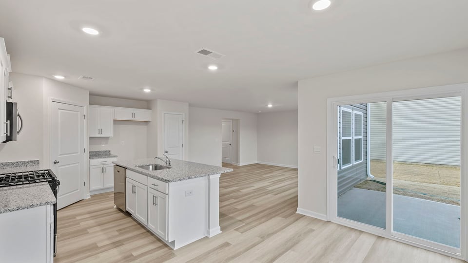 View from dining area of the open floor plan and door to the back yard.