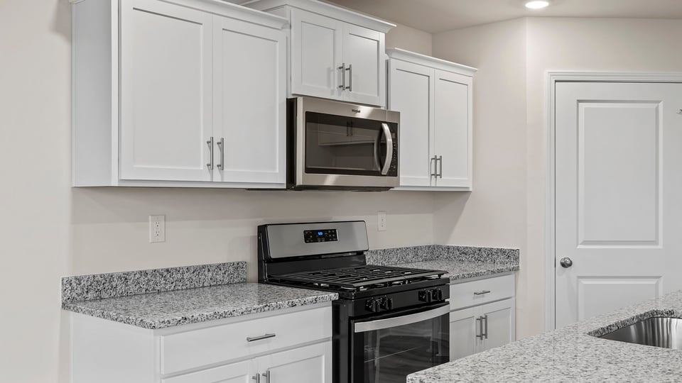Kitchen features stainless steel appliances.