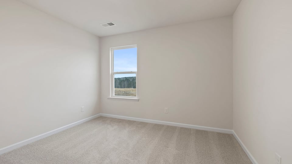 Bedroom with window and carpet.