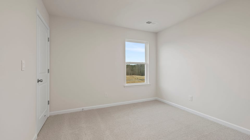 Bedroom with window and carpet.