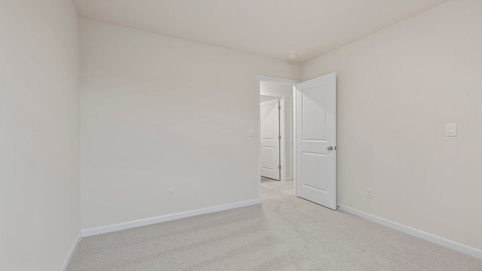 Bedroom with window and carpet.