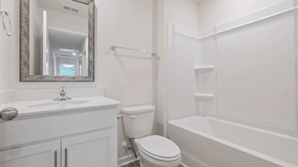 Hall bathroom with vanity and combination shower / tub.