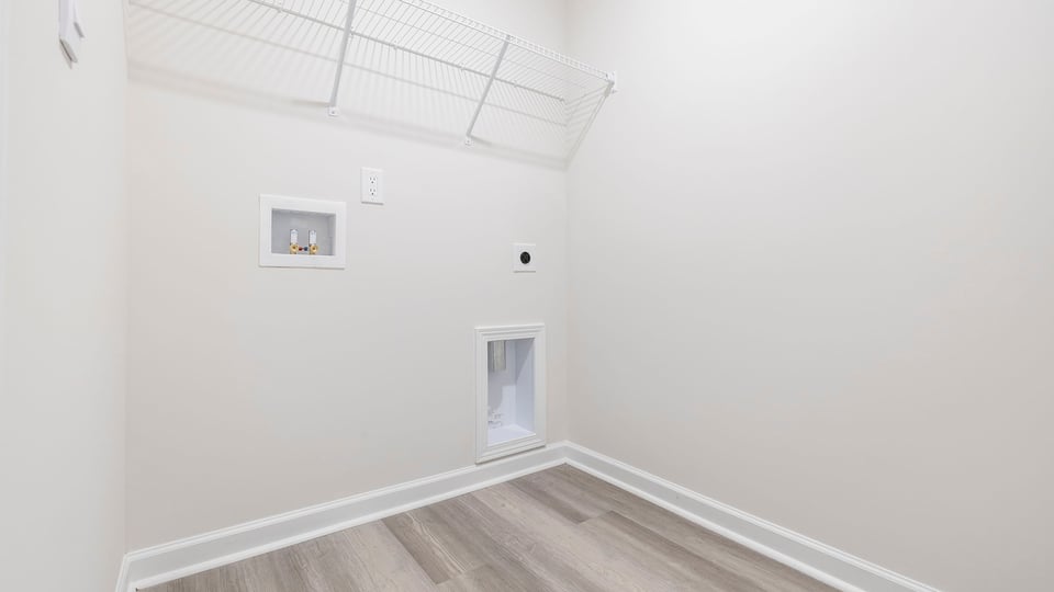 Walk-in laundry room with wire shelving.