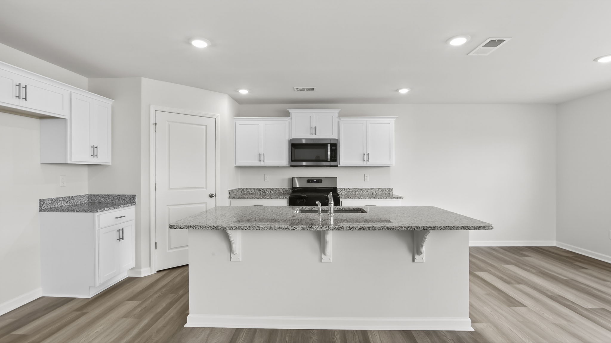 Kitchen and island with granite counter tops.