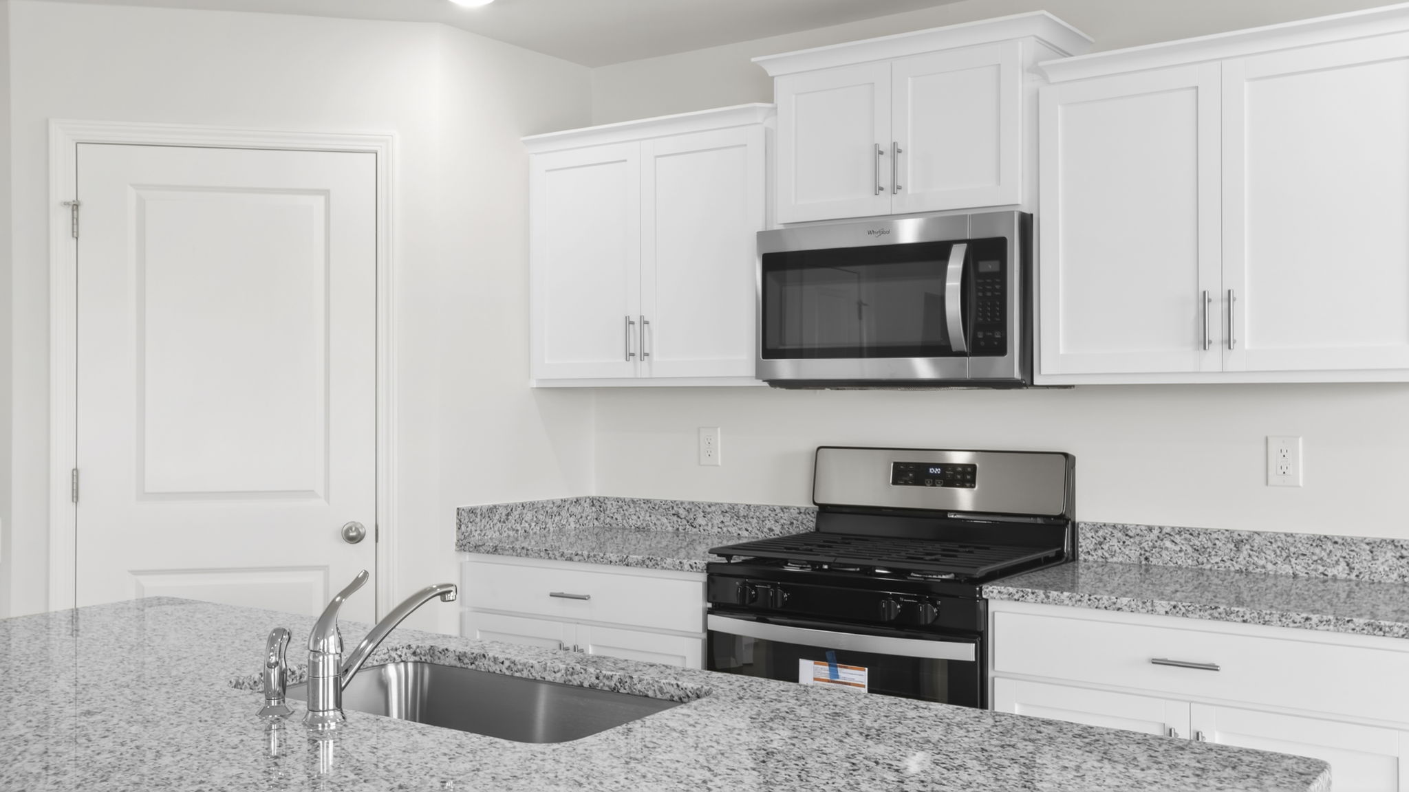 Kitchen and island with granite counter tops.