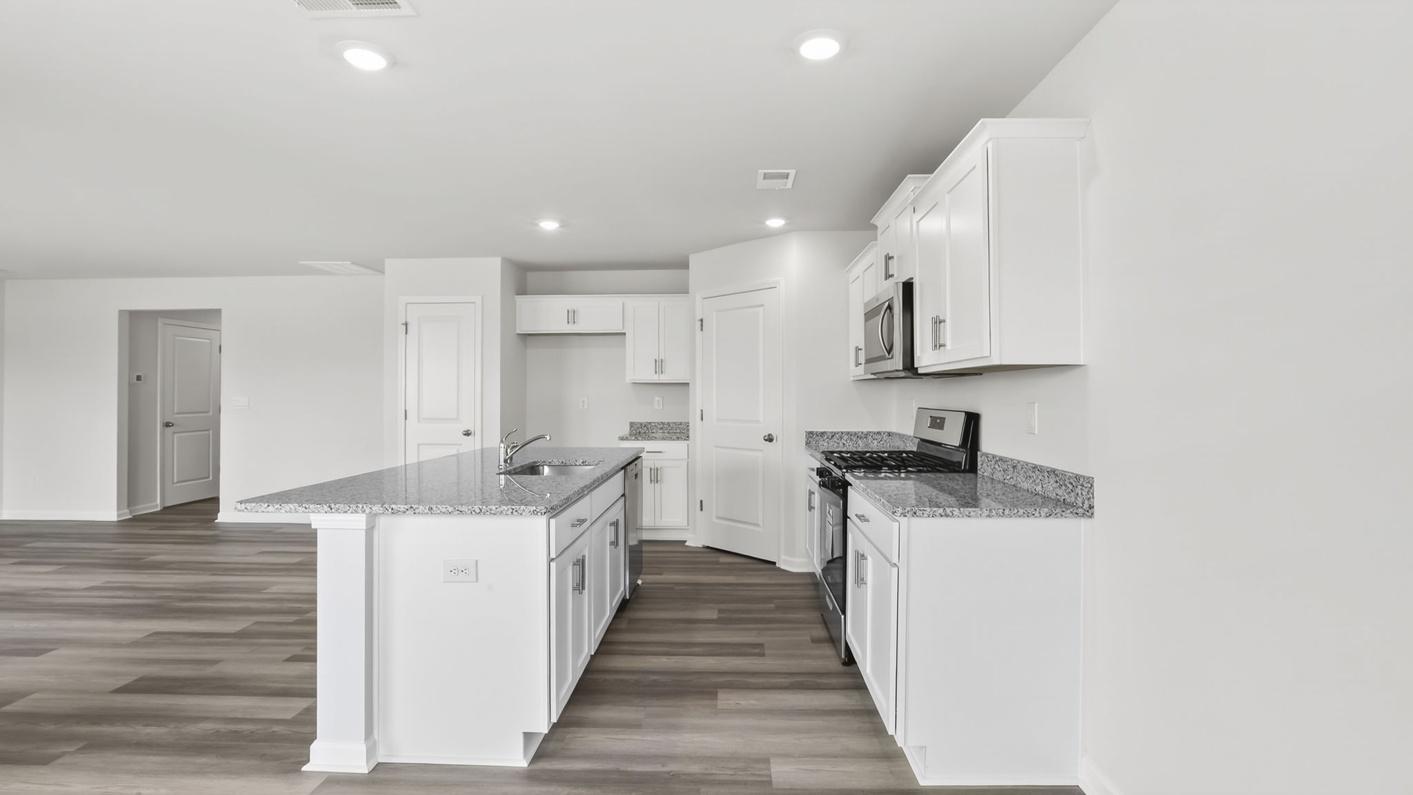 Kitchen and island with granite counter tops.