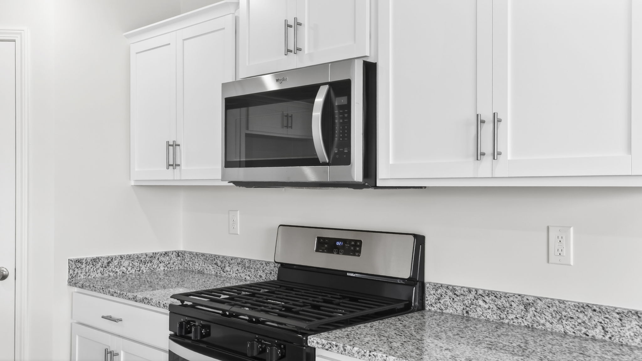 Kitchen and island with granite counter tops.