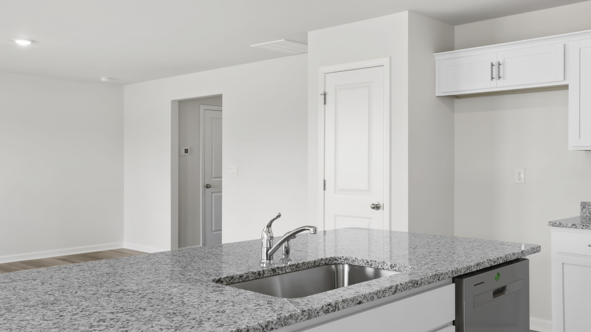 Kitchen and island with granite counter tops.