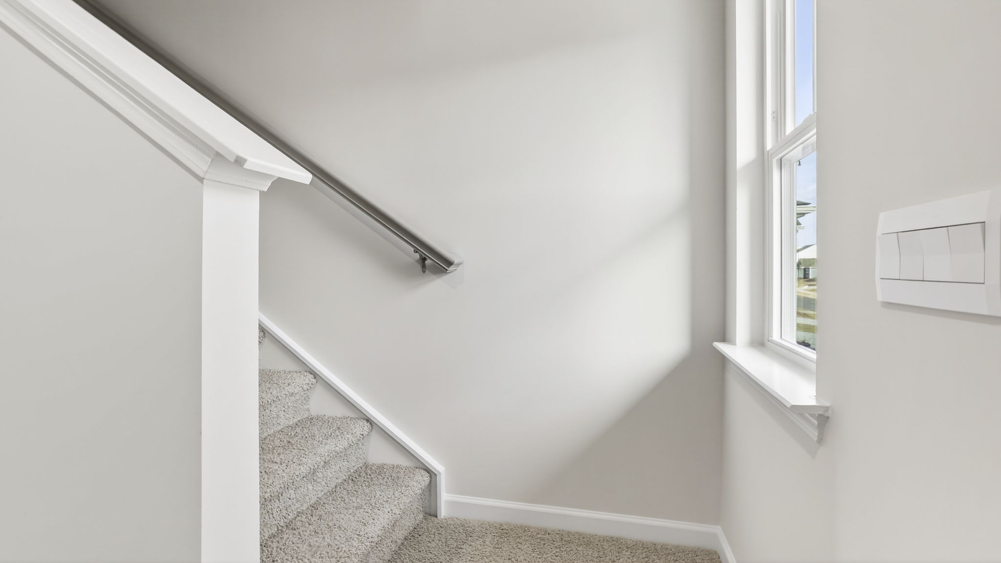 Stairs to bedrooms with carpet.