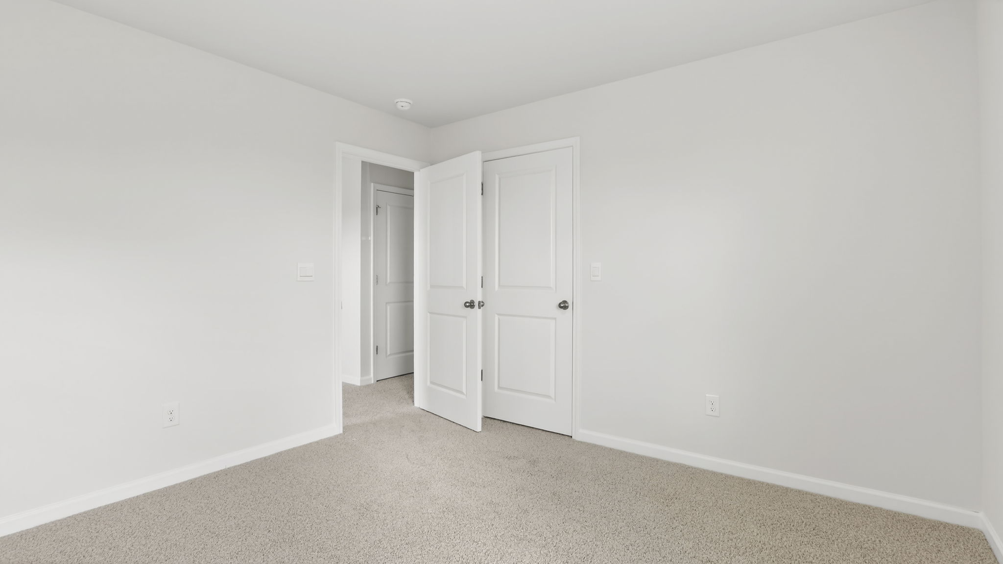 Bedroom with carpet and window.