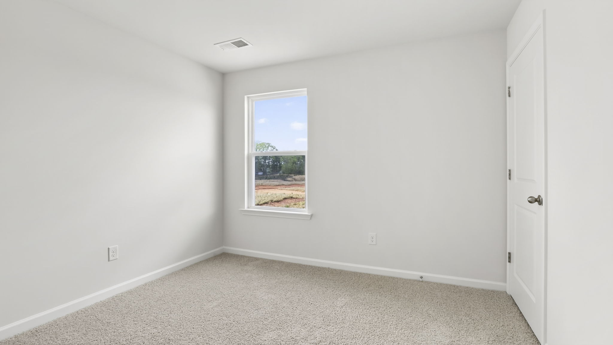 Bedroom with carpet and window.