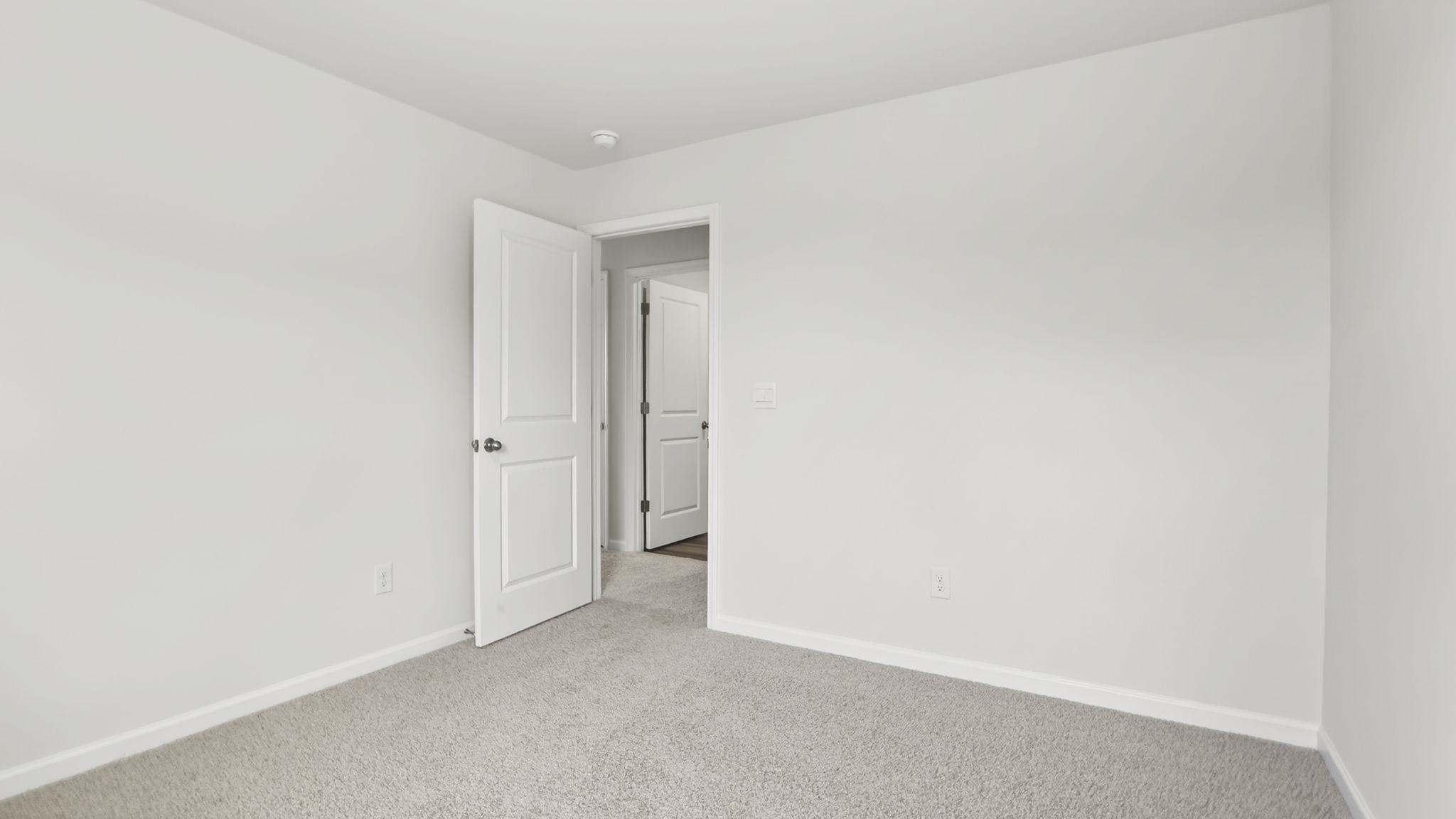 Bedroom with carpet and window.