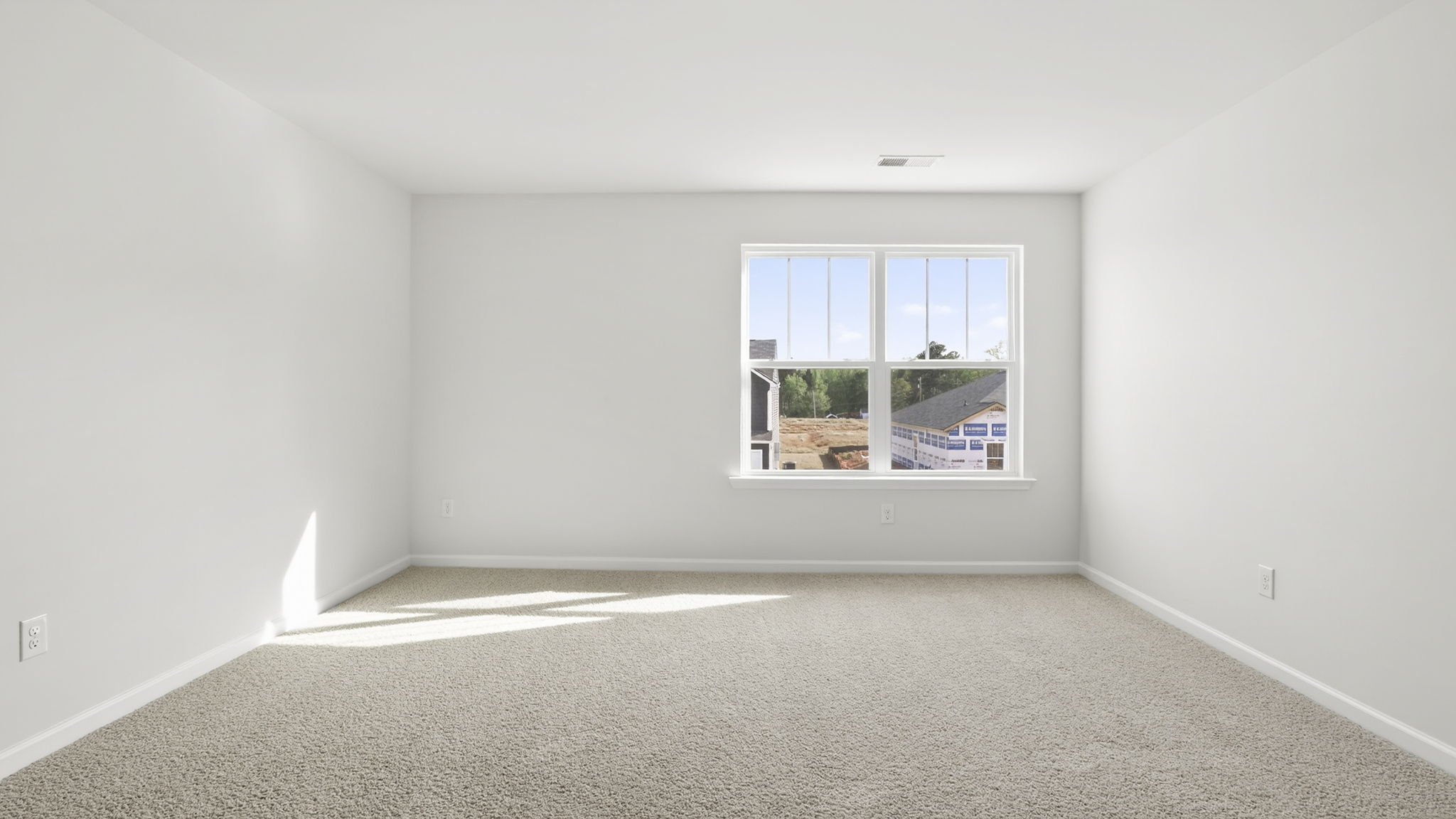 Bedroom with carpet and window.