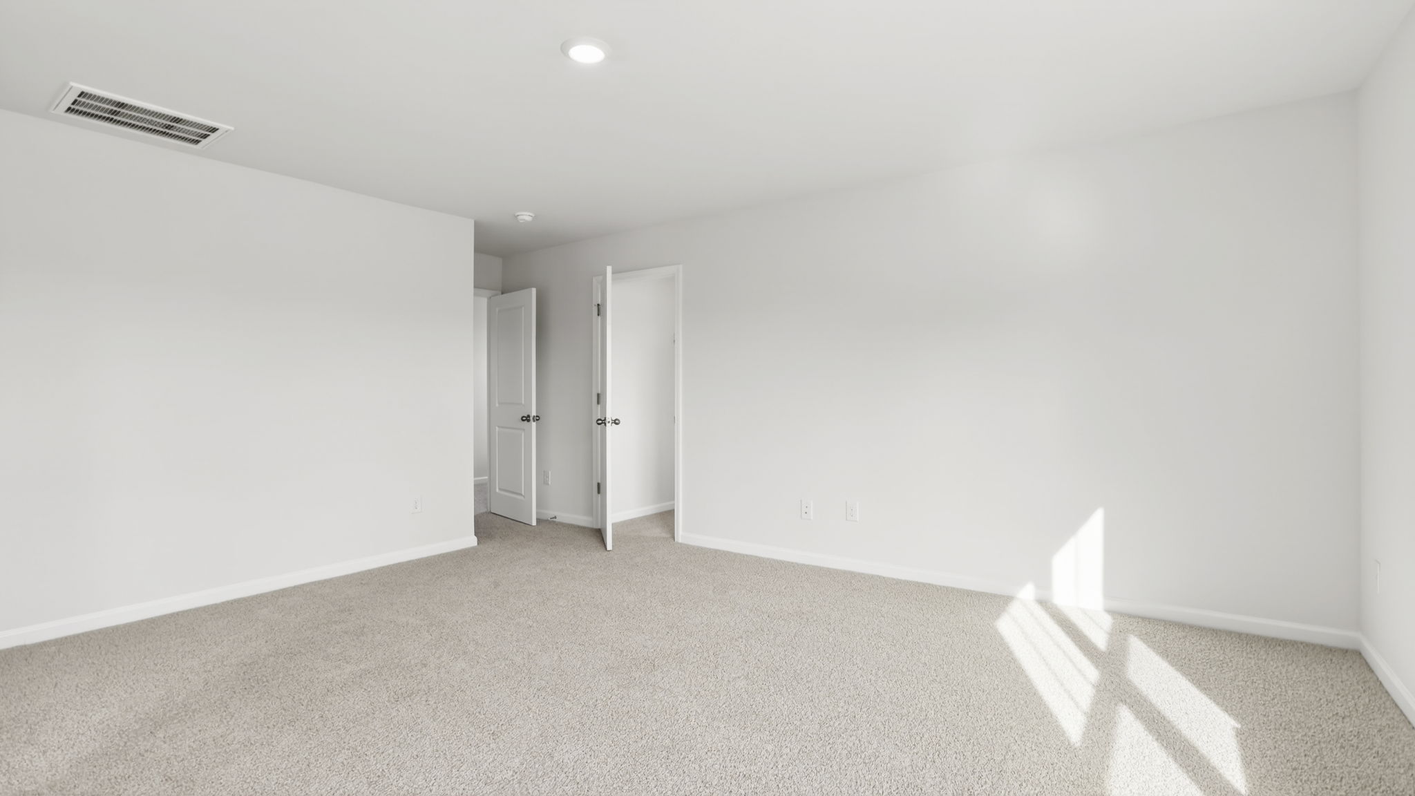 Bedroom with carpet and window.