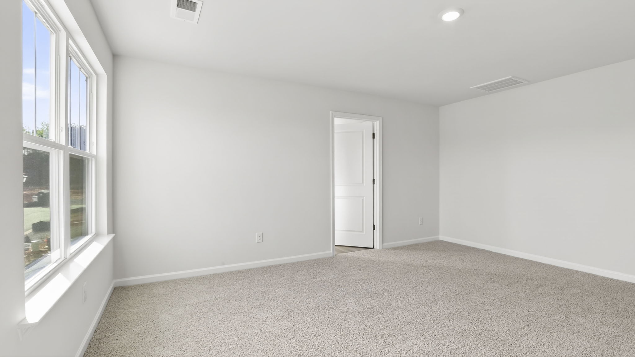 Bedroom with carpet and window.
