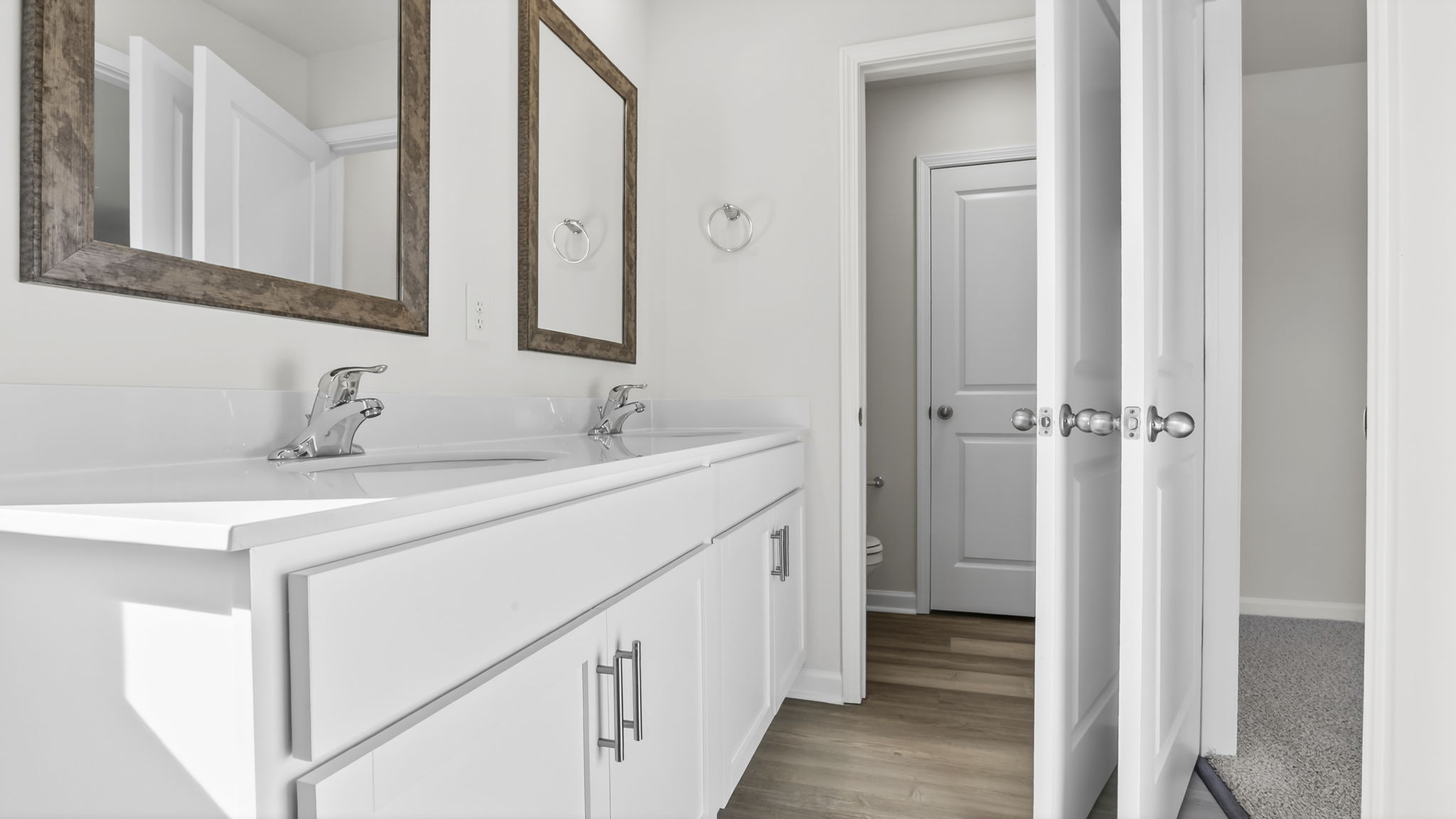 Bathroom with double vanity sink and closet.