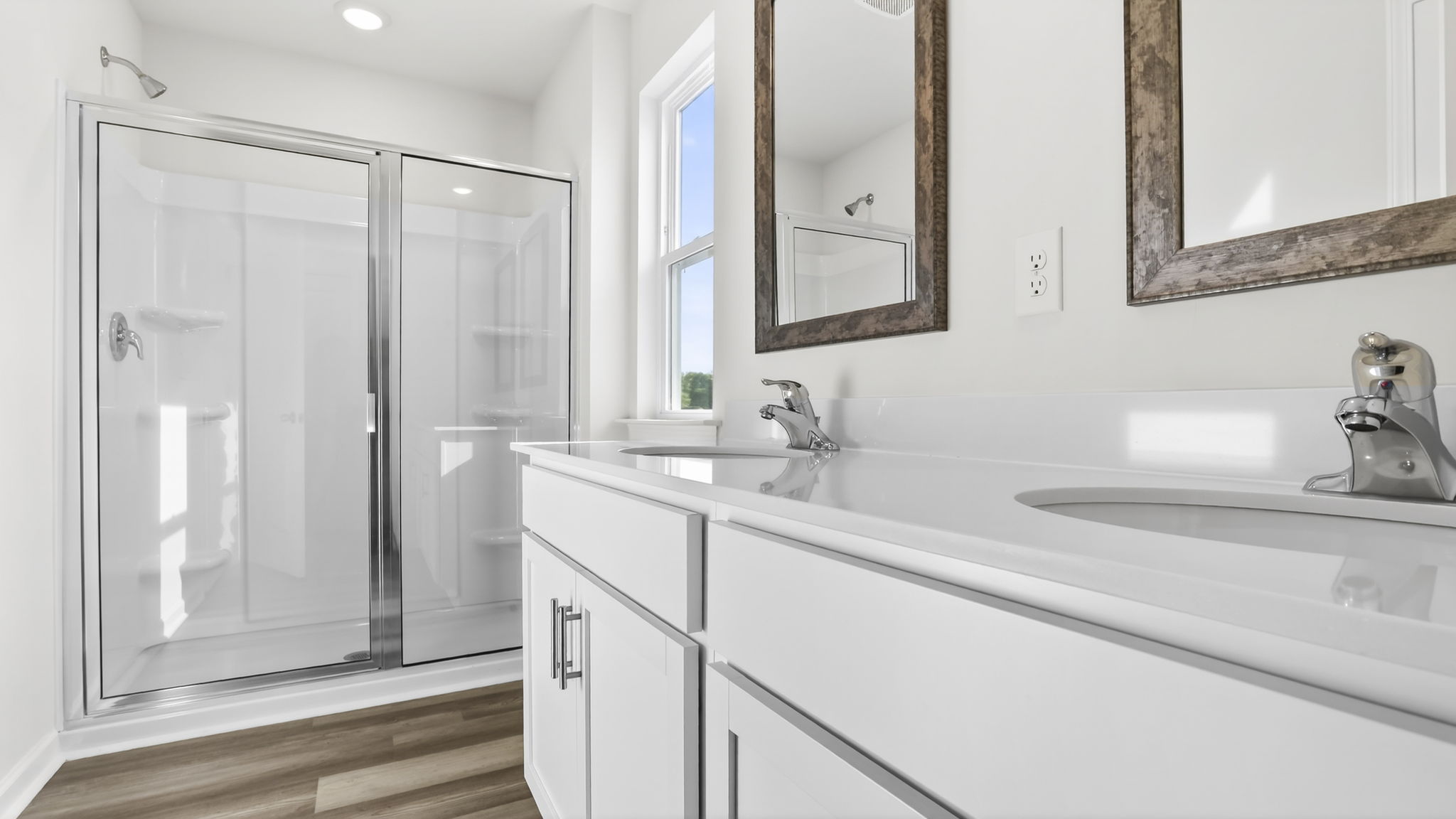 Bathroom with double vanity sink and walk in close.