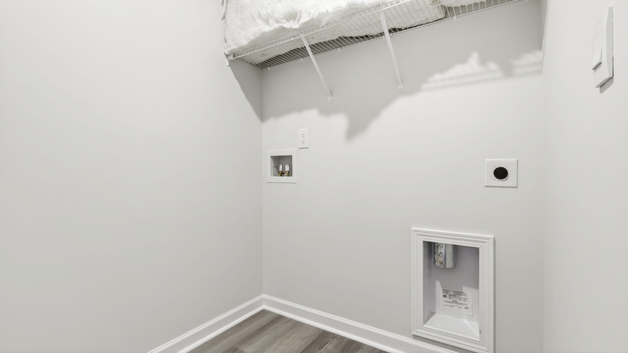 Laundry room with hanging storgae racks.