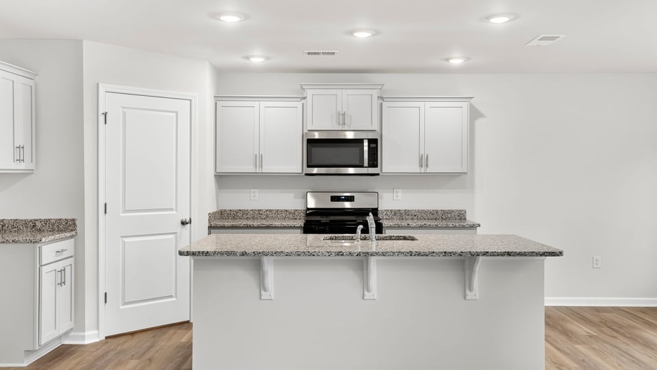 Kitchen with island and cabinets.