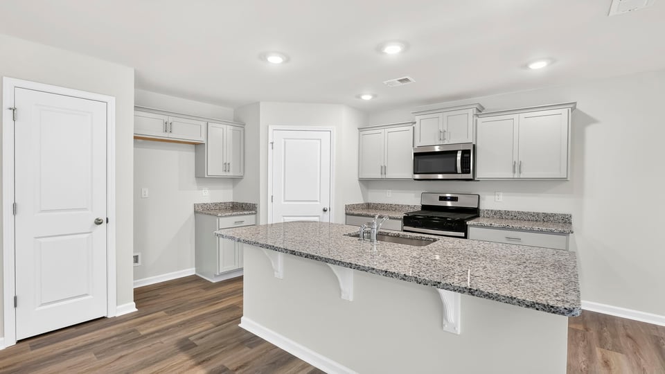 Kitchen with island and cabinets.