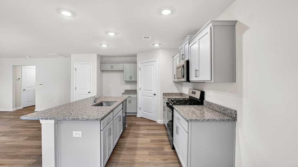 Kitchen with island and cabinets.