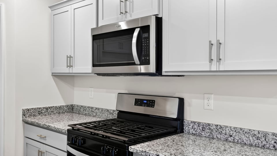 Kitchen with island and cabinets.