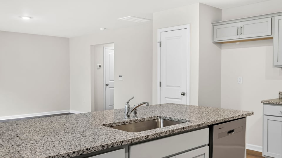 Kitchen with island and cabinets.