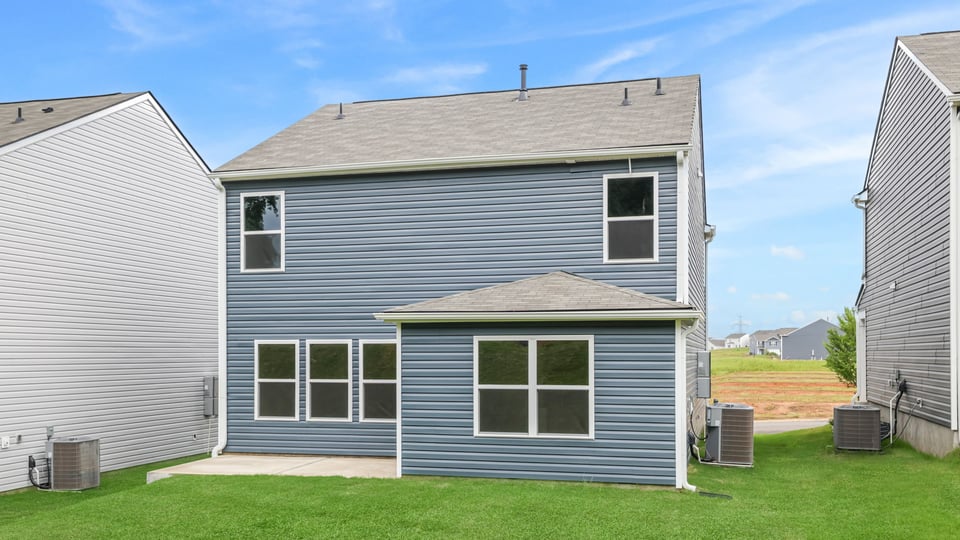 Back exterior with large backyard.